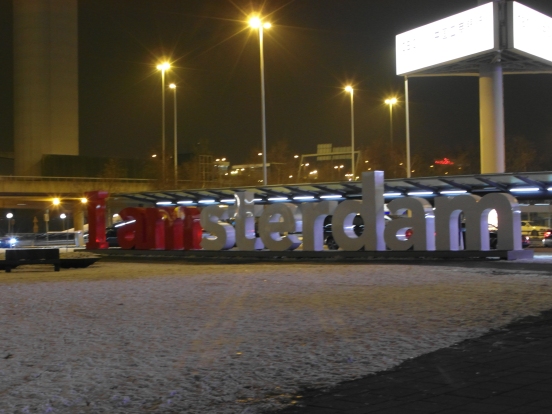 Schipol Airport's famous 'I amsterdam' sign at night in the snow.
